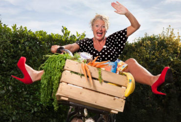 Debbie Duurzaam achter de fiets met duurzame producten in de fietsmand