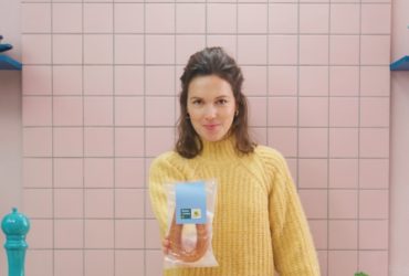 Een vrouw met een Beter Leven rookworst in haar hand